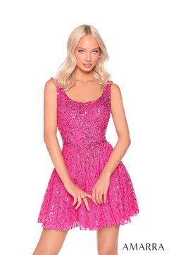 A blonde model wears a fuchsia sequined party dress with a fitted bodice and flared skirt.