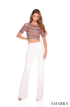 A model wears a multicolored crop top and white wide-leg pants in an Ivory/Multi color variant.