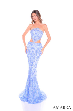 A model wears a strapless, periwinkle/silver lace mermaid gown with cutout waist and sweeping train.