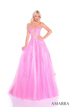 A model wears a strapless, sparkly Bright Pink ballgown with a sweetheart neckline and full tulle skirt.
