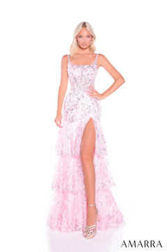 A blonde model wears a blush sequined gown with a high slit and delicate straps from Amarra.