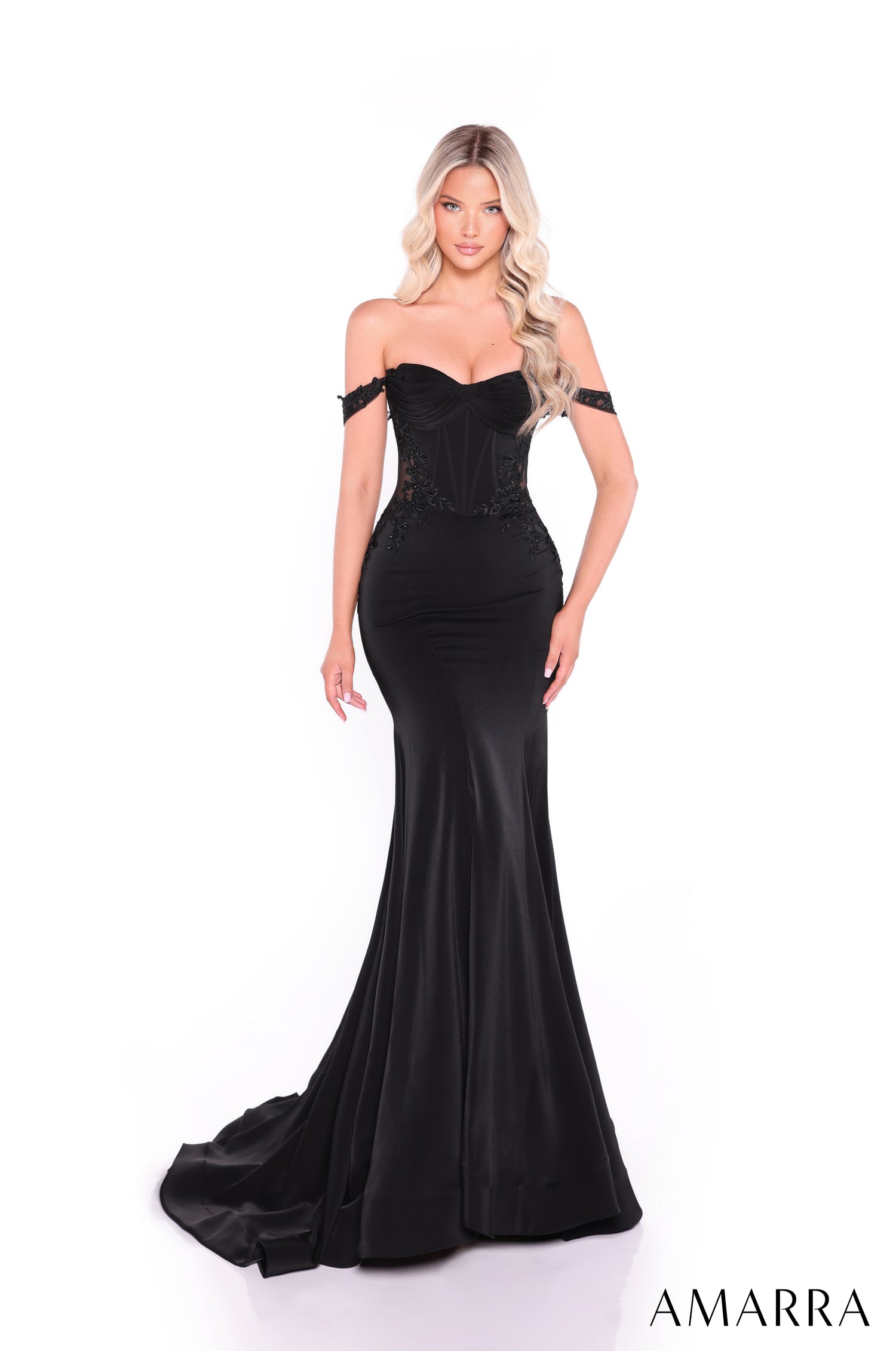 A long black mermaid-style evening gown with off-shoulder lace bodice and dramatic train.