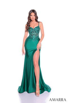 A model wears an emerald green satin gown with beaded bodice and a high side slit.
