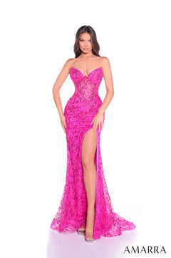 A woman wearing a form-fitting fuchsia lace gown with a high slit and strapless sweetheart neckline.