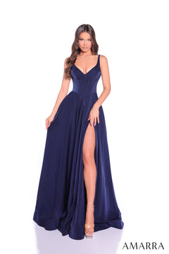 A model wears a navy floor-length gown with a deep v-neck, fitted bodice, and high side slit.