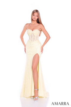 A model wears a strapless, light yellow sequin gown with a high slit and silver heels.