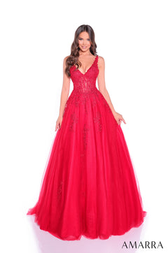 A woman wears a full-length, lace-bodiced Red ball gown with a v-neck and voluminous tulle skirt.
