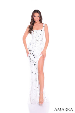A floor-length white gown with silver speckles and a high side slit, worn with clear heels.