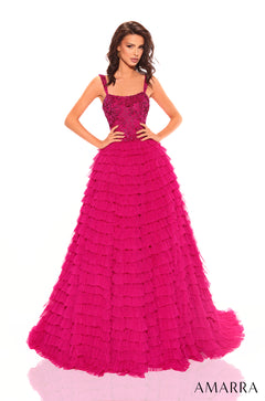 A woman wears a floor-length, ruffled Bright Fuchsia ball gown with an embellished bodice.