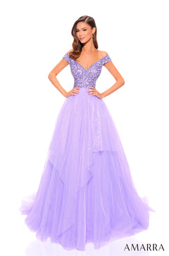 A model wears a lilac off-shoulder ball gown with a beaded bodice and flowing tulle skirt.