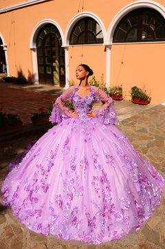 A lavender ball gown with 3D floral details stands against an arched yellow building with stone pathway.