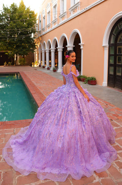 A lavender ball gown with floral details on a woman standing by a pool near an arched building.