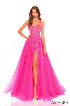 A model wears a fuchsia lace ballgown with a high slit and sweetheart neckline.