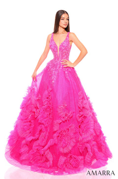 A model wears a voluminous Fuchsia/Multi ballgown with a deep V-neckline and ruffled, embellished skirt.