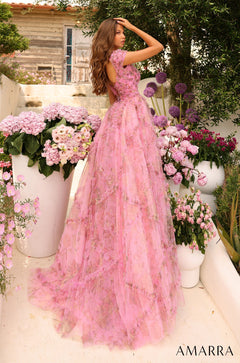 A woman in a voluminous pink floral gown stands in a garden surrounded by pink and purple blooms.