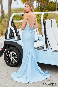 A light blue mermaid-style formal dress with a low back, posed next to a white and blue golf cart.