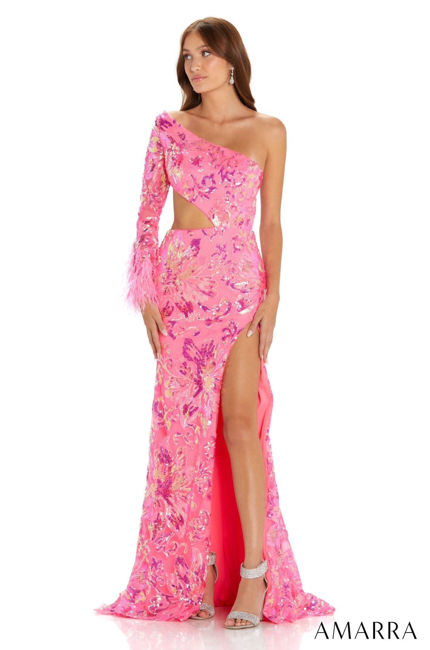 A pink one-shoulder sequin gown with a high slit and feather trim, worn with silver strappy heels.