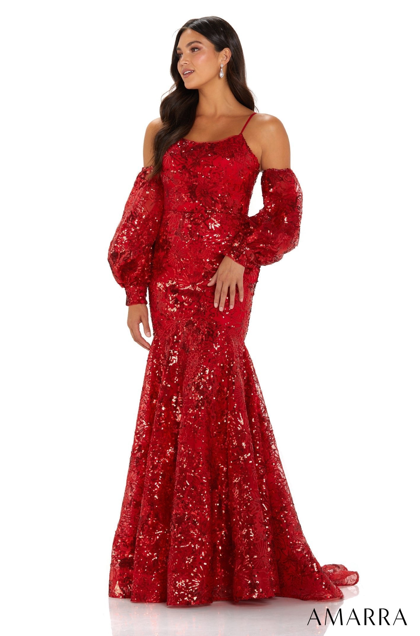 A woman wears a glittering red sequin mermaid gown with off-shoulder bishop sleeves.