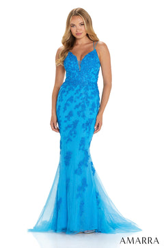 A bright blue mermaid-style evening gown with sequined lace and thin straps, flaring out at the bottom with tulle.