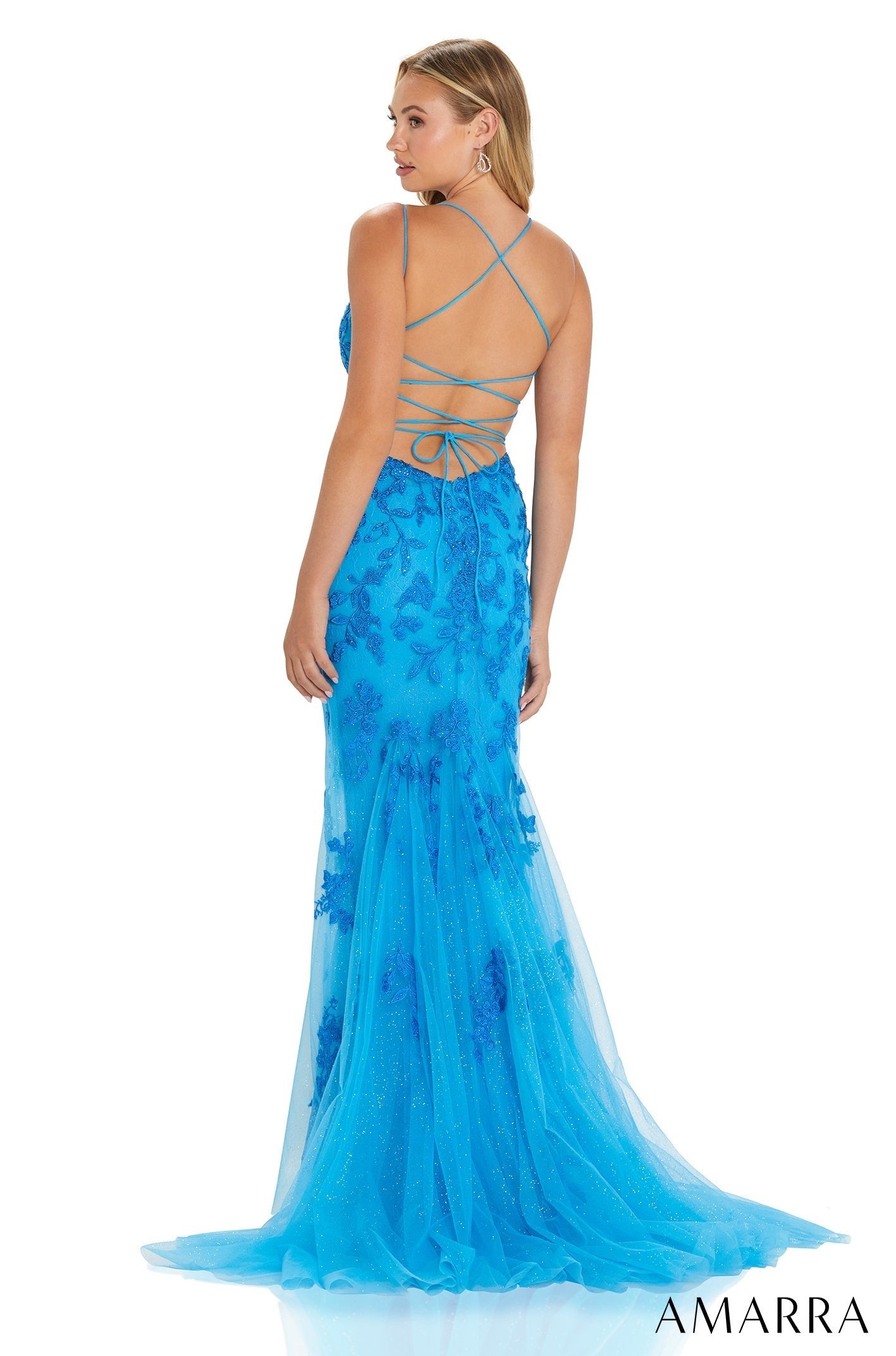 A blue tulle mermaid gown with a strappy back and floral embroidery sweeps the floor.