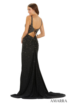 A model wears a black sparkling floor-length gown with a low back and corset-style lace-up detail.
