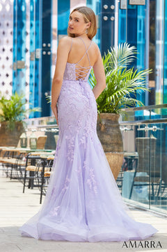 A lavender lace mermaid gown with a corset back, photographed from behind in a modern glass-walled setting.