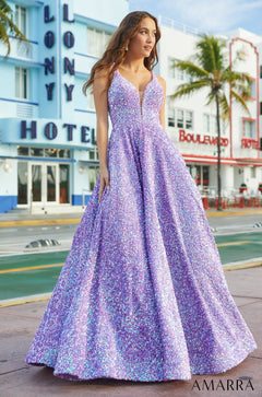 A model wears a full-length, sequined lavender ballgown standing on a Miami street with hotels behind her.