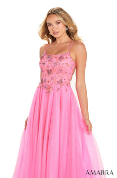 Pink sequined prom dress with spaghetti straps and a flowing skirt, modeled by a blonde woman.