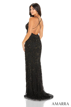 A person wears a long black sparkly evening gown with criss-cross back straps at a product photoshoot.