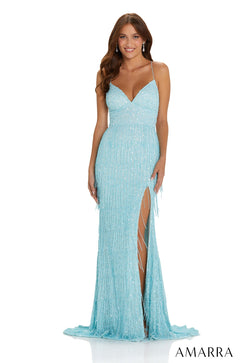 A model wears a sparkling light blue sequin gown with a thigh-high slit and thin straps.