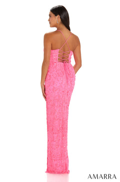 A woman wears a long, hot pink sequined dress with a criss-cross back, viewed from behind.